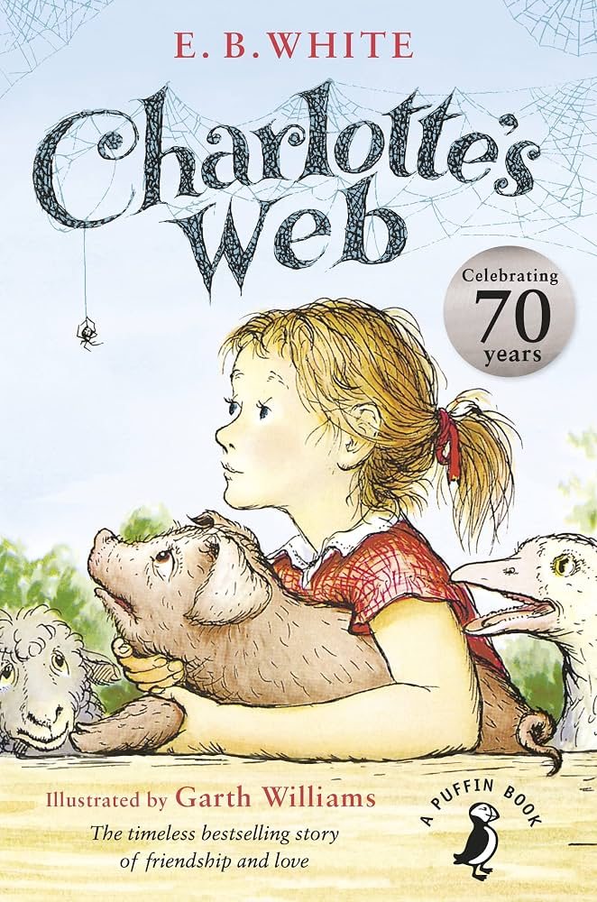 Book cover of Charlotte’s Web: a girl in a red dress holds a pig, with a sheep and a goose beside her and a spider hanging from the title.