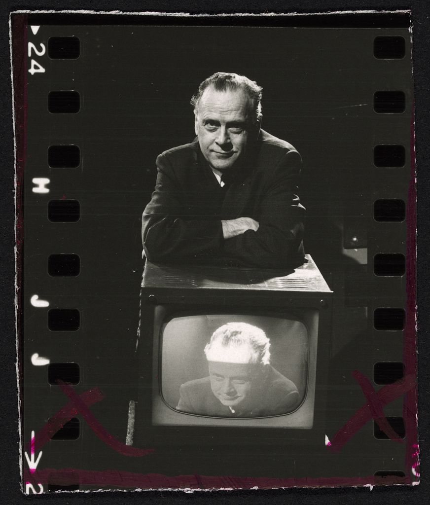 Marshall McLuhan, beside a television and on it, 1967.