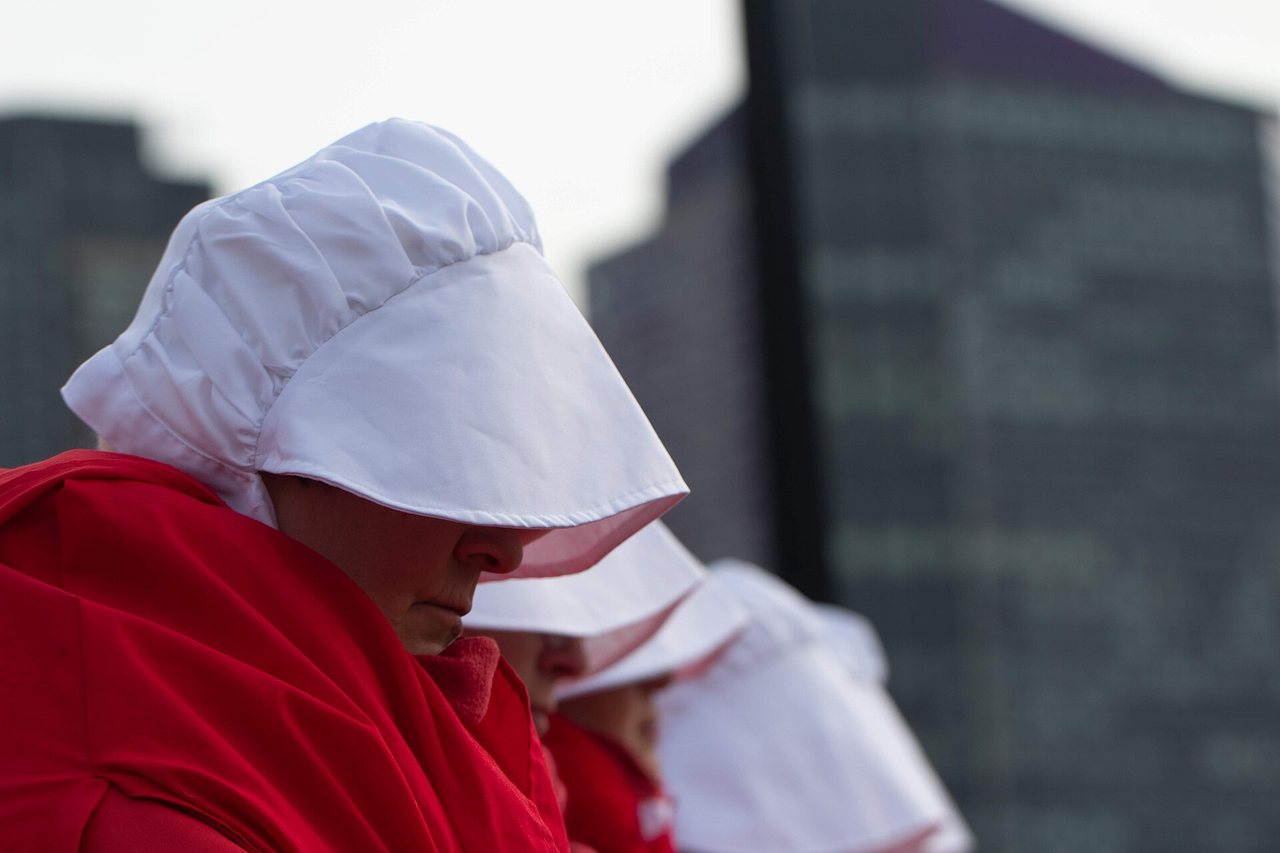 Marchers dressed as handmaids, Boston, 2019.