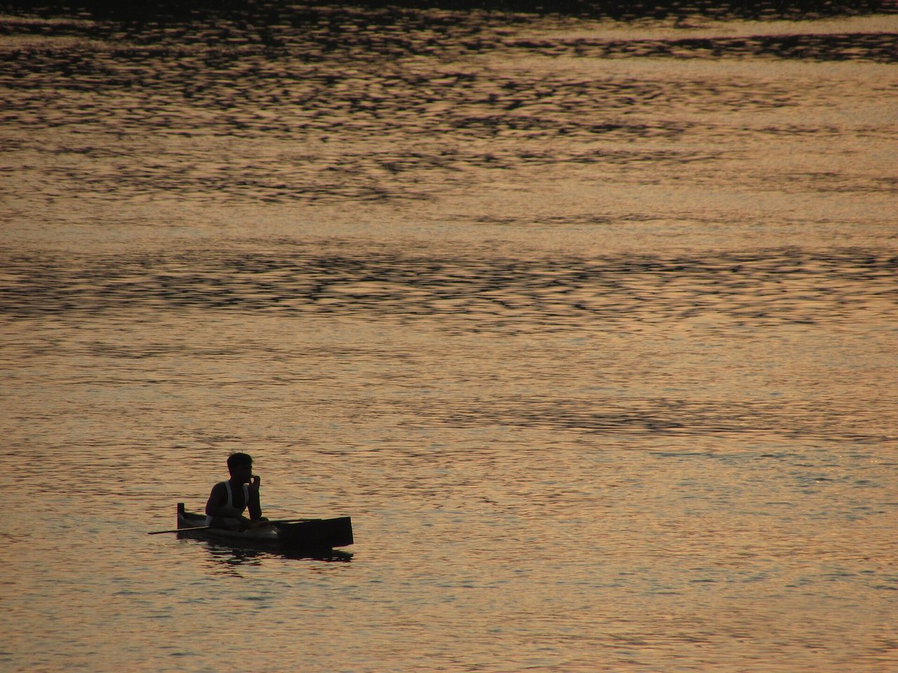 A boat on the Ganges at sunset.