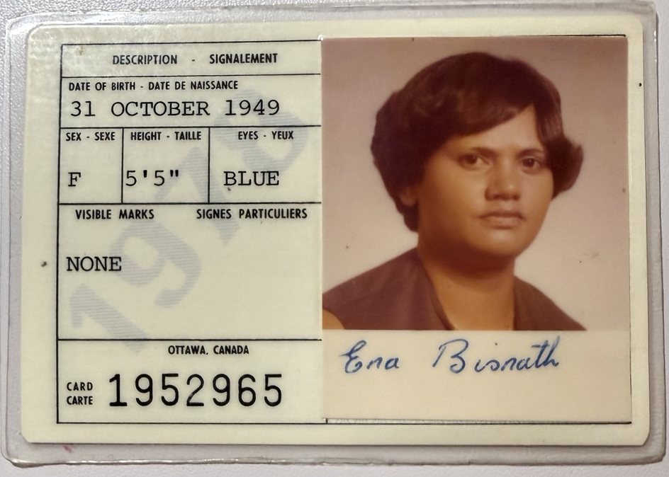 A laminated Canadian citizenship card: a colour photo of a woman with short dark hair, her signature under it, and a faint 1978 printed across the description panel.