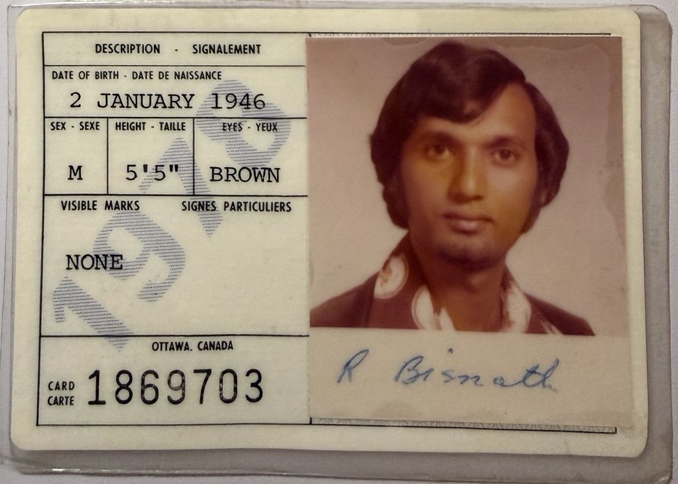 A laminated Canadian citizenship card: a colour photo of a man with dark hair and a patterned collar, his signature under it, and a faint 1978 printed across the description panel.