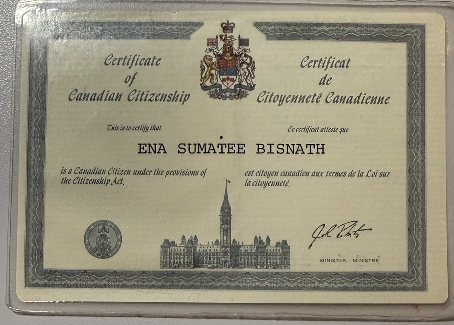 A wallet-size Certificate of Canadian Citizenship in English and French, with the Canadian coat of arms, a drawing of Parliament and the name Ena Sumatee Bisnath.